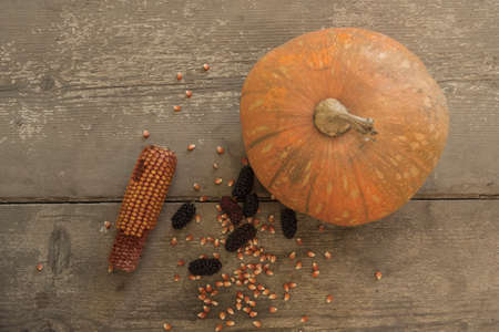 blacks mulberry and corn kernels to pop corn on the rough wooden table.の写真素材