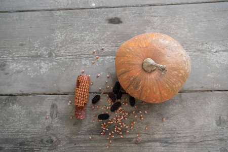 blacks mulberry and corn kernels to pop corn on the rough wooden table.の写真素材