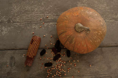 blacks mulberry and corn kernels to pop corn on the rough wooden table.の写真素材