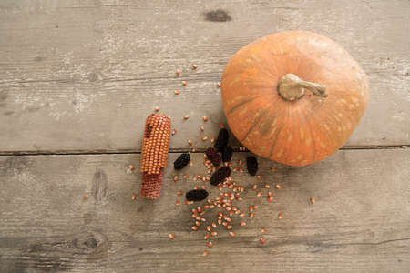 blacks mulberry and corn kernels to pop corn on the rough wooden table.の写真素材