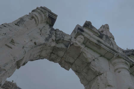 Roman amphitheater. External view of the arena and the ancient ruins. In the background the gray and...
