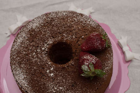 donut strawberry with icing sugar and strawberry on pink and white tablecloth tray.の写真素材