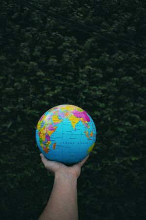 Man Holding a Globe in his Handの写真素材