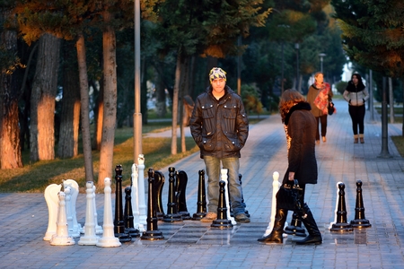 SUMGAIT, AZERBAIJAN - JANUARY 17 2014 Couple playing street chess in Sumgait, Azerbaijan. A couple play a game of street chess in a park in central Sumgait, around 30km from the capital, Bakuのeditorial素材