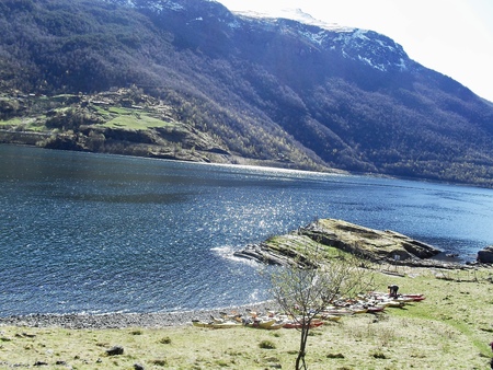 Kayaks on the beach of a Norwegian fjord.の写真素材