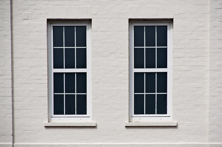 two sash windows in a white wallの写真素材