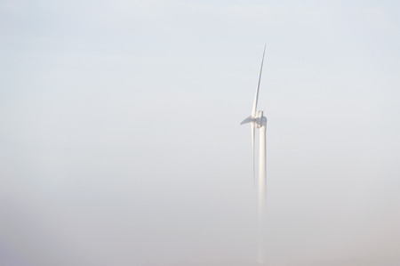 wind turbine rising out of mistの写真素材