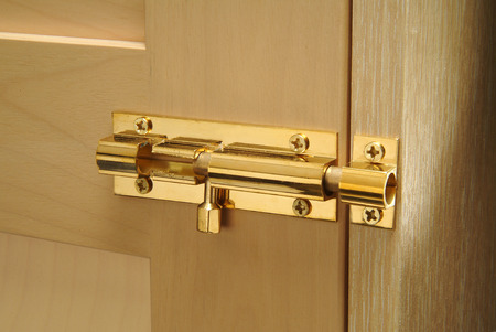 Brass bolt on cabinet doorの写真素材