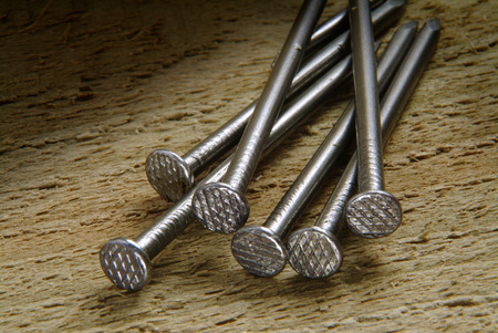 Round nails on wooden backgrouindの写真素材