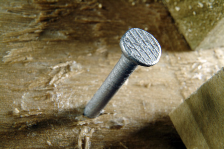 nail half driven into timberの写真素材