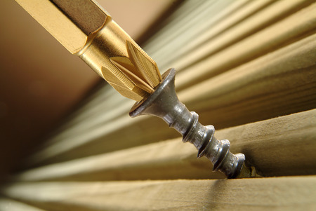 Screw being driven into timber deckingの写真素材