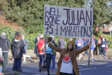 Worthing, Sussex, UK; 11th February 2018; Woman Holding a Homemade Banner Supporting a Runner in the Annual worthing Half Marathon Eventのeditorial素材
