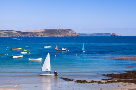 Small sailing boat on a beach with beautiful beach, Portscatho Cornwall England UKの写真素材
