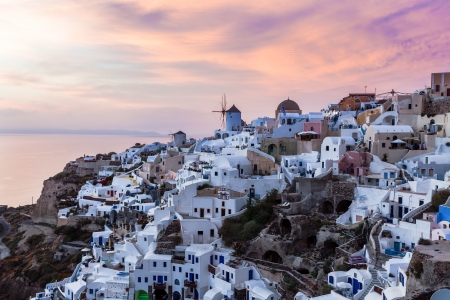 Vibrant sunset over houses and villas at Oia Santorini Greeceの写真素材