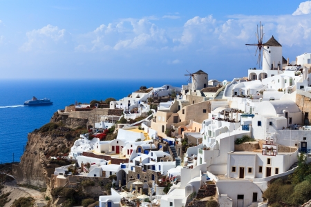 Tradational Windmills and white buildings at Oia Santorini Greeceの写真素材
