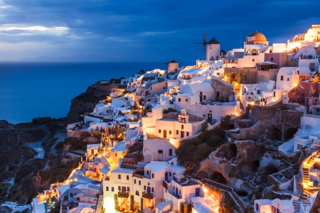 Dusk overlooking buildings on the Caldera at Oia Santorini Greece Europeの写真素材