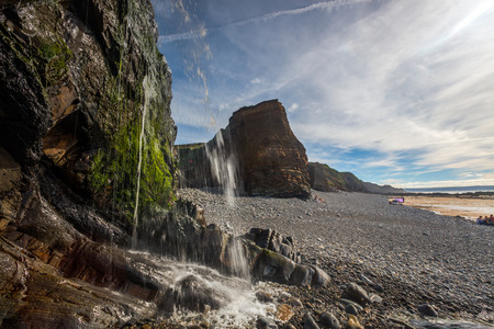 Waterfall on the beach at Sandymouth near bude Cornwall England UK Europeの写真素材