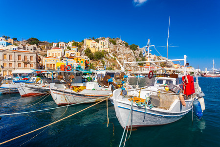 Traditional Greek fishing boats in harbour at Symi Town in the Dodecanese Greece Europe