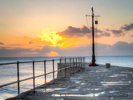Sunset over Porthleven Pier Cornwall England UK Europeの写真素材