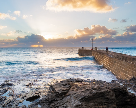 Sunset over Porthleven Pier Cornwall England UK Europeの写真素材