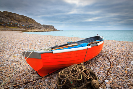 Boat on the beach at Chesil Cove on the Isle Of Portland Dorset England UK Europeの写真素材
