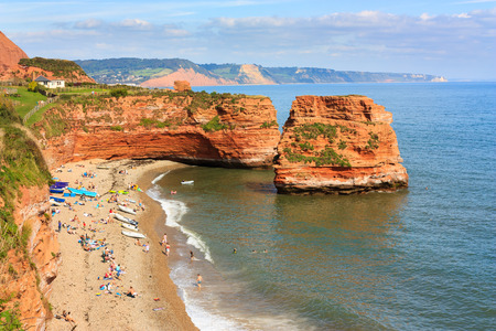 Dramtic red Jurassic cliffs and sea stacks  at Ladram Bay Devon England UK Europeの写真素材