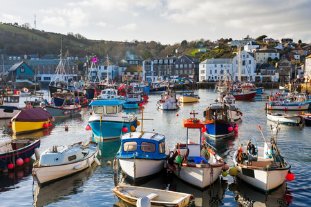 Small fishing boats in the historic harbour at Mevagissey Cornwall England UK Europeの写真素材