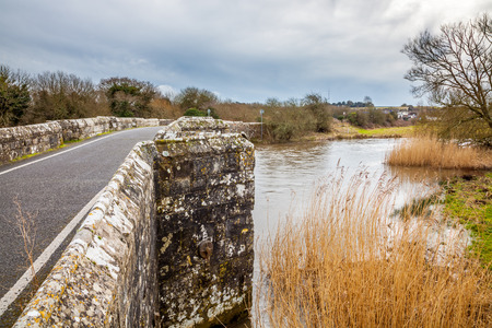 The River Frome and the historic  Wool Bridge Dorset England UK Europeの写真素材