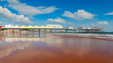 Paignton pier reflected in the wet and on the Beach Devon England UK Europeのeditorial素材
