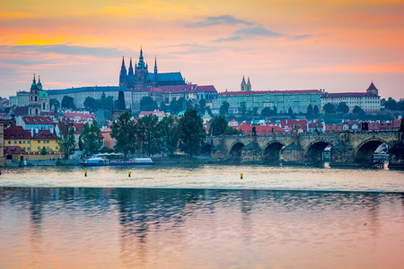 Sunset over Charles Bridge and Prague Castle from Smetanovo nabrezi along the River Vltava. Prague...
