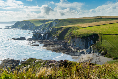 Overlooking the rugged coastline at Ayrmer Cove near  Challaborough Devon England UKの写真素材