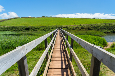Wooden Bridge across the river at South Milton Ley Nature Reserve Devon England UK Europe