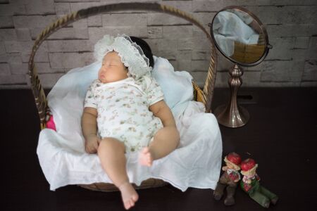 After infant eat breast milk from her mother and the she sleep on the pad bedの写真素材