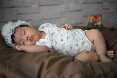 After infant eat breast milk from her mother and the she sleep on the pad bedの写真素材