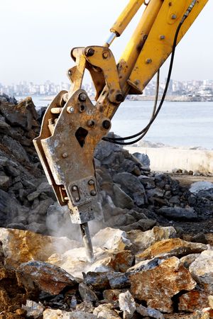 A hydraulic arm with impact breaker in actionの写真素材