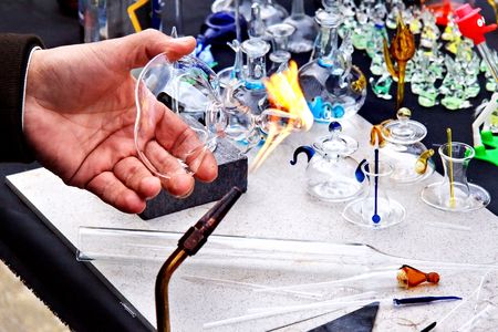 Artist hand heats up the glass.の写真素材