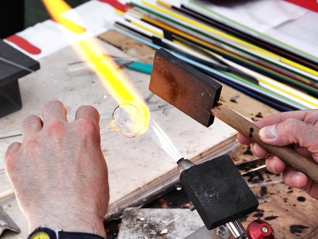 Glass blower forming a piece of glass