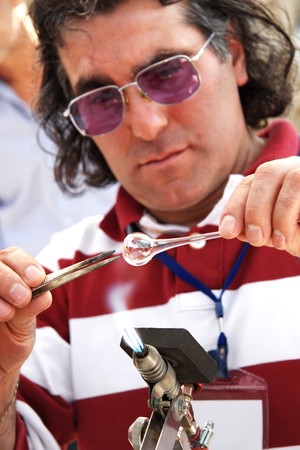 Istanbul - April 25, 2010: Glass blower working with molten glass to be blown at Maltepe campusのeditorial素材