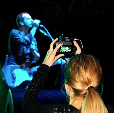 Istanbul - May 14, 2010: Professional photographer captures live performance of Band Mor ve Otesi at Maltepe open air stage. のeditorial素材