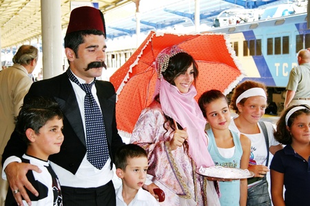 ISTANBUL - SEPTEMBER 02, 2009: Orient Express arrives at last stop at 14:30 pm. Young couple in Ottoman costume greets the travellersのeditorial素材