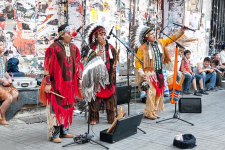 Unidentified Amerindians perform in traditional costumes during street show at Istiklal Street on July 06, 2010 in Istanbul. Beyoglu district is the major strolling street  in city.のeditorial素材