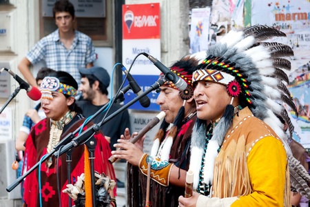 Unidentified Amerindians perform in traditional costumes during street show at Istiklal Street on July 06, 2010 in Istanbul. Beyoglu district is the major strolling street in city.のeditorial素材