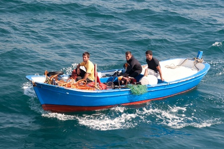 ISTANBUL, TURKEY - JULY 7 : Fisherman drive to offshore fishing in Bosporus on July 7, 2010 in Istanbul. The fishing contributes a significant income to people here.のeditorial素材