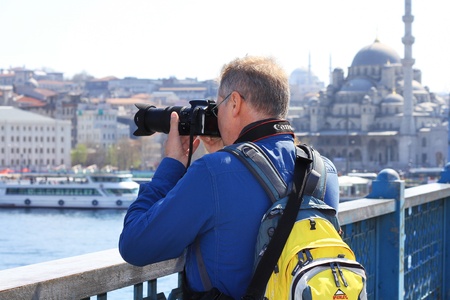 ISTANBUL - APRIL 12: An unidentified tourist on Galata Bridge of Goldenhorn on April 12, 2012 in Istanbul. The bridge is the major strolling and tourism center in city.のeditorial素材