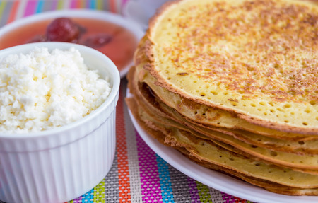 Pancakes with strawberry jam, cheese .