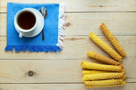 Freshly honey waffles rolled up into tubes on a blue napkinの写真素材