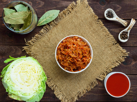 Braised cabbage with spices in a tomato sauce in a white bowl. The top view.の写真素材
