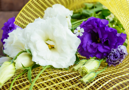 Freshly picked white and purple flowers eustomy (lisianthus)  on the wooden background. Close upの写真素材