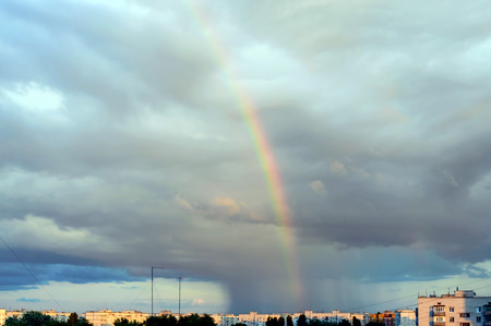 A colorful rainbow in the sky over the city. After the rainの写真素材