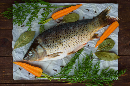 River fish - bream with spices on a wooden background. The top view.